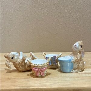 Ceramic egg holders.  Bunnies snd baskets. Set of 4